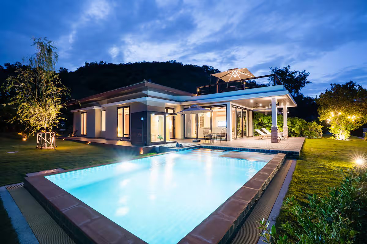 Villa exterior with pool at twilight